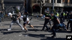 Police use pepper spray on protesters during an anti-lockdown protest in Melbourne, Australia, Aug. 21, 2021.