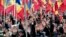 FILE - People raise their hands during an anti-government protest in Chisinau, Moldova, Jan. 24, 2016. The election of a pro-Russian president in the impoverished former Sovet republic is widely seen as a vote against the pro-Europe policies of previous Moldovan leaders.
