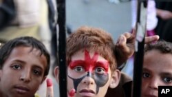 Boys take part in a rally to celebrate the departure of Yemen's President Ali Abdullah Saleh to Saudi Arabia for medical treatment in Sanaa, June 5, 2011