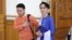 Aung San Suu Kyi walks with a NLD member into parliament in Naypyitaw, Myanmar, March 11, 2016. (Z. Aung/VOA News)