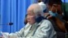 Khieu Samphan, left, the former head of state for the Khmer Rouge, sits in a courtroom during a hearing at the U.N.-backed war crimes tribunal in Phnom Penh, Cambodia, Aug. 19, 2021.