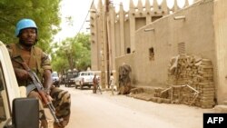 FILE - A peacekeeper with the United Nations patrols outside the mosque in Mopti, central Mali, May 30, 2018.