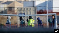 Teen migrants walk in line inside the Tornillo detention camp in Tornillo, Texas, Dec. 13, 2018.