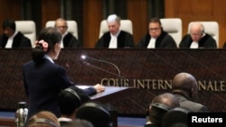 Myanmar's leader Aung San Suu Kyi speaks in front of the judges on the second day of hearings in a case filed by Gambia against Myanmar alleging genocide against the minority Muslim Rohingya population, at the International Court of Justice (ICJ) in The H
