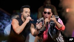 FILE - Singers Luis Fonsi, left and Daddy Yankee perform during the Latin Billboard Awards in Coral Gables, Fla., April 27, 2017. Malaysia has banned their hit song "Despacito" on state radio and television. 