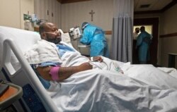 Cedric Daniels, 37, of Gonzales, La., rests in his room, recovering from COVID-19 at Our Lady of the Lake Regional Medical Center in Baton Rouge, La., Aug. 2, 2021.