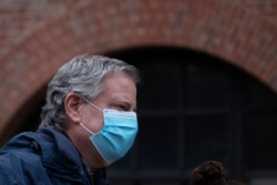 FILE - Mayor Bill de Blasio wears a mask while honoring health care workers during the coronavirus pandemic, in New York, April 24, 2020.