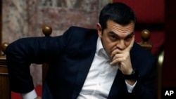 Greece's Prime Minister Alexis Tsipras joins a parliament session in Athens, Feb. 8, 2019. Greek lawmakers became the first to ratify Macedonia's NATO accession.