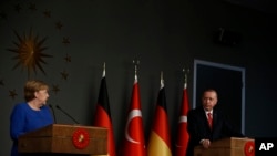 Germany's Chancellor Angela Merkel talks during a news conference with Turkey's President Recep Tayyip Erdogan following their meeting in Istanbul, Jan. 24, 2020. 