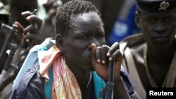 Rebel fighters listen to their commander in rebel-controlled territory in Upper Nile State, Feb. 15, 2014. 