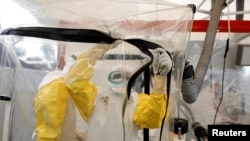 FILE - A health worker wearing Ebola protection gear works at an Ebola treatment center in Beni, in the Democratic Republic of Congo, April 1, 2019. 