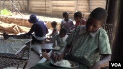 Orphans in Harare's Kambuzuma township eat a meal provided by the charity Faith Community Support, Nov. 28, 2019. (Columbus Mavhunga/VOA)