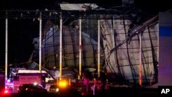 First responders work outside an Amazon fulfillment center after it was heavily damaged when a storm moved through the area Dec. 10, 2021, in Edwardsville, Ill. 