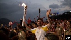 Leonardo Espindola carries the Olympic torch on its way to Rio de Janeiro for the opening ceremony of Rio's 2016 Summer Olympics, in Niteroi, Brazil on Aug. 2, 2016