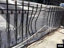 The fence near the Erawan shrine, blasted outward by the bomb explosion. (Steve Herman/VOA News)