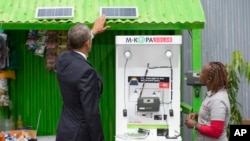 FILE - President Barack Obama looks at a solar power exhibit during a tour of the Power Africa Innovation Fair, Saturday, July 25, 2015, in Nairobi, Kenya. In Nigeria, Lumos Global is among the firms rolling out solar power technology.