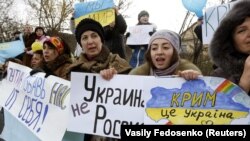 UKRAINE – Participants hold placards and shout slogans during an anti-war rally in the Crimean village of Eskisaray, outside Simferopol, March 10, 2014