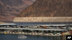 A bathtub ring of light minerals delineates the high water mark on Lake Mead at the Lake Mead National Recreation Area, Thursday, Aug. 13, 2020, near Boulder City, Nevada.
