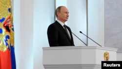 Russia's President Vladimir Putin delivers his annual state of the nation address to the Federal Assembly at the Kremlin in Moscow, Dec. 4, 2014.