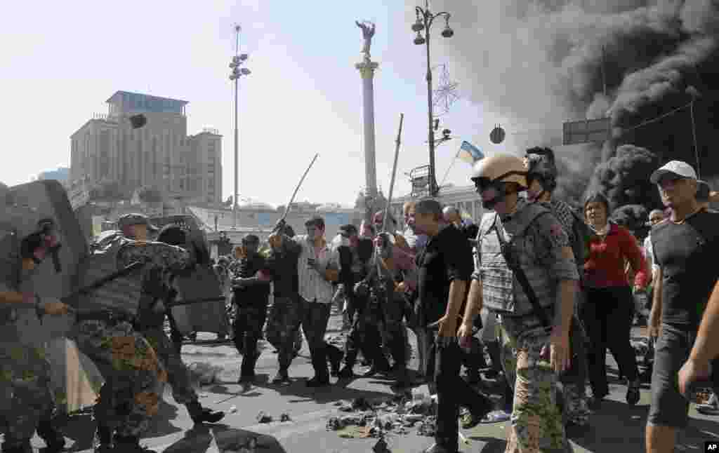 Activists clash with a special forces police battalion, in Independence Square, Kyiv, Ukraine, Aug. 7, 2014.