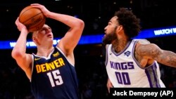 Nikola Jokić šutira za pobedu protiv Sakramenta, dok Vili Koli-Stajn pokušava da ga zaustavi (Foto: AP/Jack Dempsey)