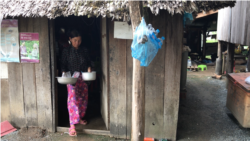 Food​ ​vendor​ ​Kong​ ​Sina​ ​emerges​ ​from​ ​her​ ​kitchen​ ​in​ ​Trach​ ​Village​ ​of​ ​Cambodia’s​ ​Kampong​ ​Speu​ ​province​.​ ​(​Aun​ ​Chhengpor​/​VOA​ ​Khmer​)​