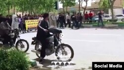 In this frame from a social media video posted April 13, 2018, people in Khorasgan, Iran march to protest water shortages that are hurting local farmers. 