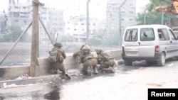Israeli soldiers operate in Jabalia in the northern Gaza Strip, amid the ongoing conflict between Israel and the Palestinian Islamist group Hamas, in this screen grab taken from a video released on Dec. 9, 2023. (Israel Defense Forces via Reuters)