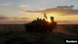 Ukrainian paratroopers ride on an armored vehicle near Debaltseve, Sept. 13, 2014. 