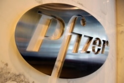 FILE - The Pfizer company logo is photographed at Pfizer Inc. headquarters, in New York, Dec. 4, 2017.