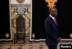 FILE - Guinea-Bissau President Jose Mario Vaz arrives to speak with journalists after a meeting with Portuguese officials at the presidential palace in Lisbon, June 19, 2014.