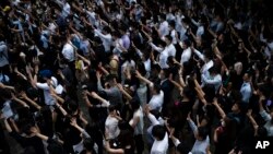 People display opened palm with five fingers, signifying the five demands of anti-government protesters during a march at Central district in Hong Kong, Wednesday, Oct. 2, 2019.