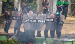 FILE - This screengrab provided via AFPTV and taken from a broadcast by Myitkyina News Journal on March 27, 2021, shows security forces cracking down on protesters during a demonstration against the military coup in Myanmar's Kachin state.
