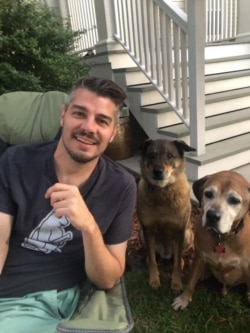 Joe Frisard with his dogs, Robert and Bruno. Frisard is a freelancer in New Orleans. He rents out a portion of his home through Airbnb, but the coronavirus pandemic has cut his income by more than 40%. (Photo Courtesy Joe Frisard)