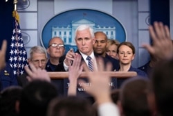 Vice President Mike Pence points to a question as he speaks during a briefing about the coronavirus in the James Brady Press Briefing Room of the White House, Sunday, March 15, 2020, in Washington.