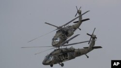 FILE - Two U.S. Black Hawk helicopters participate in a media demonstration.