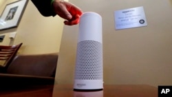 FILE - An Amazon Alexa device is switched on for a demonstration of its use in a ballpark suite before a Seattle Mariners baseball game in Seattle, WA., May 17, 2017.