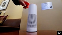 FILE - An Amazon Alexa device is switched on for a demonstration of its use in a ballpark suite before a Seattle Mariners baseball game in Seattle, WA., May 17, 2017.