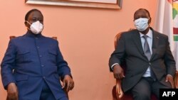 Ivory Coast's president Alassane Ouattara (R) and former president and opposition leader Henri Konan attend their first meeting since the national election in Abidjan on November 11, 2020. - Ivory Coast President Alassane Ouattara invited his chief…