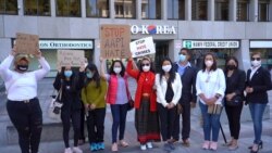A group of Asian communities holds signs during a press conference calling to a halt on violence against Asian Americans in Los Angeles, CA March 23, 2021
