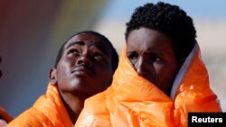 Migrants stand in line after disembarking from the Norwegian vessel Siem Pilot at Pozzallo's harbor, Italy, March 29, 2016. 