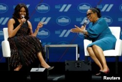 FILE - First lady Michelle Obama and television presenter Oprah Winfrey participate in the White House's "United State of Women" summit in Washington, June 14, 2016.