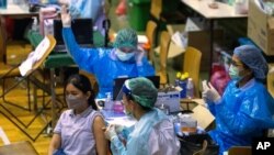 A health worker administers a dose of the Sinovac COVID-19 vaccine to a woman at Thai-Japan Bangkok Youth Center in Bangkok, Thailand, June 14, 2021.