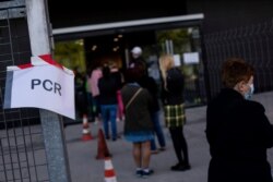 People queue for a rapid antigen test for COVID-19 in the southern neighborhood of Vallecas in Madrid, Spain, Oct. 1, 2020.