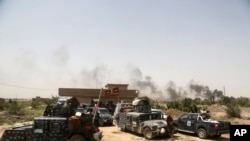 Smoke rises from Islamic State positions as Iraqi federal police take combat positions at the front line during fight against IS outside Fallujah, May 28, 2016. 