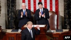 President Donald Trump, flanked by Vice President Mike Pence and House Speaker Paul Ryan of Wis., gestures on Capitol Hill in Washington, Feb. 28, 2017, before his address to a joint session of Congress. 