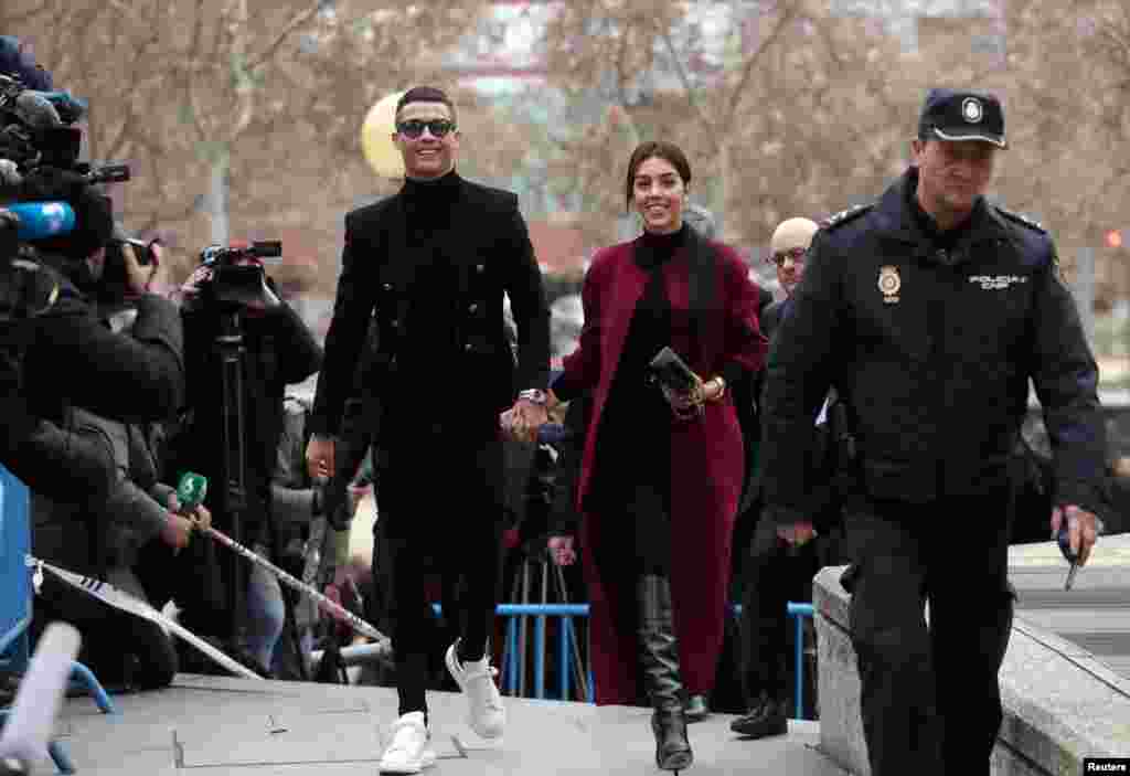 Portugal&#39;s soccer player Cristiano Ronaldo arrives with his girlfriend Georgina Rodriguez to appear in court on a trial for tax fraud in Madrid, Spain.