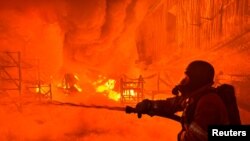 ইউক্রেনের খারকিভে রাশিয়ার ড্রোন হামলার একটি জায়গায় একজন দমকলকর্মী কাজ করছেন, ৪ মে, ২০২৪। 