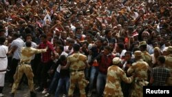  FILE -- Demonstrators chant slogans and flash the Oromo protest gesture during Irreecha, the thanksgiving festival of the Oromo people, in Bishoftu town, Oromia region, Ethiopia, Oct. 2, 2016. 