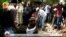 In this image taken from OBN video, the coffin carrying Ethiopia singer Hachalu Hundessa is lowered into the ground during the funeral in Ambo, Ethiopia, July 2, 2020. 